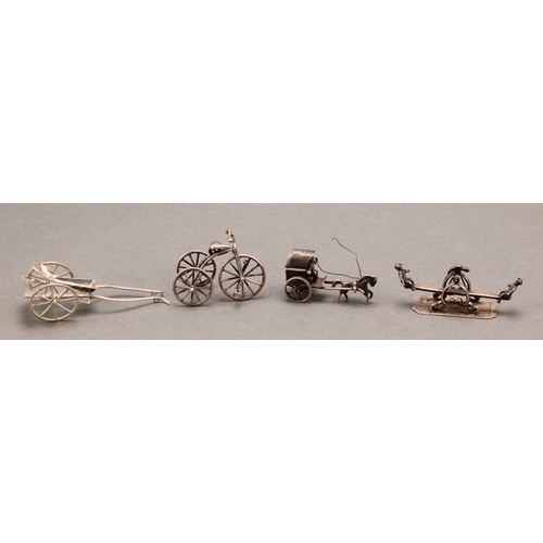 1124 - Silver Toys and Miniatures - a tricycle; a see-saw; horse drawn vehicles (4), 82g