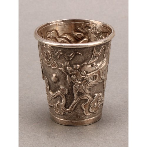 725 - A Chinese silver tapered cylindrical beaker, chased with a dragon chasing a pearl, 4.5cm high, Wang ... 