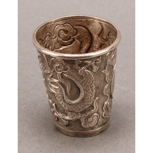 725 - A Chinese silver tapered cylindrical beaker, chased with a dragon chasing a pearl, 4.5cm high, Wang ... 