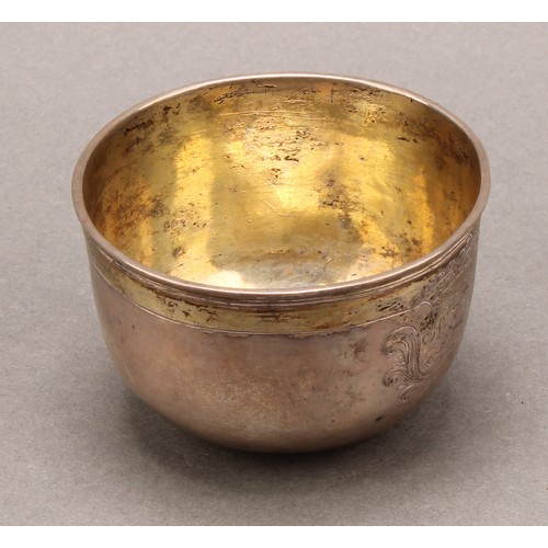 707 - A 17th century parcel-gilt silver tumbler cup, possibly Scandinavian, engraved with a crown cartouch... 