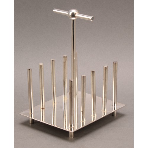 677 - A Modernist E.P.N.S toast rack, of Christopher Dresser inspiration, posted T-bar handle, 13cm long, ... 