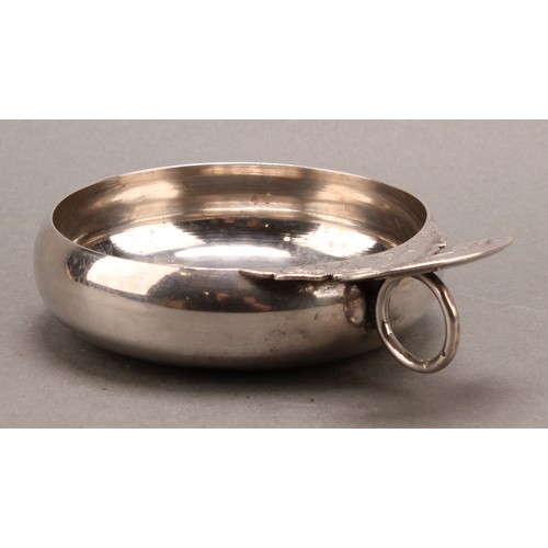 989 - An 18th/early 19th century Dutch silver porringer or wine taster, shaped lug and ring handle engrave... 