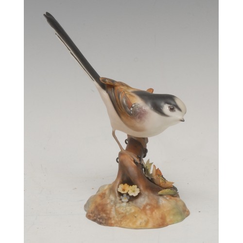 201 - A Royal Crown Derby porcelain model, of a Long Tailed Tit, painted in polychrome, 14cm high, printed... 