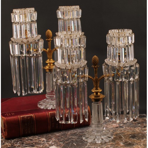 2479 - A pair of Regency gilt brass and cut glass two light table lustre candelabra, each branch fitted wit... 