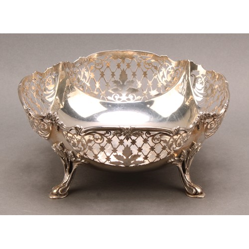 819 - A George V silver quatrefoil bowl, pierced with trellis and leafy scrolls, shaped rim chased with fl... 