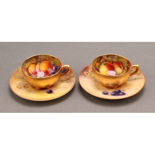 130 - A pair of Royal Worcester cabinet cups and saucers, painted by T. Lockyer, signed, with ripening fru... 