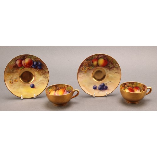 130 - A pair of Royal Worcester cabinet cups and saucers, painted by T. Lockyer, signed, with ripening fru... 