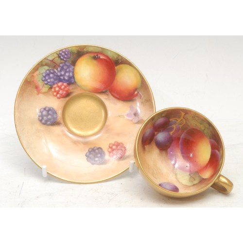 143 - A Royal Worcester cabinet cup and saucer, painted by W. Bee, signed, with ripening fruit on a mossy ... 