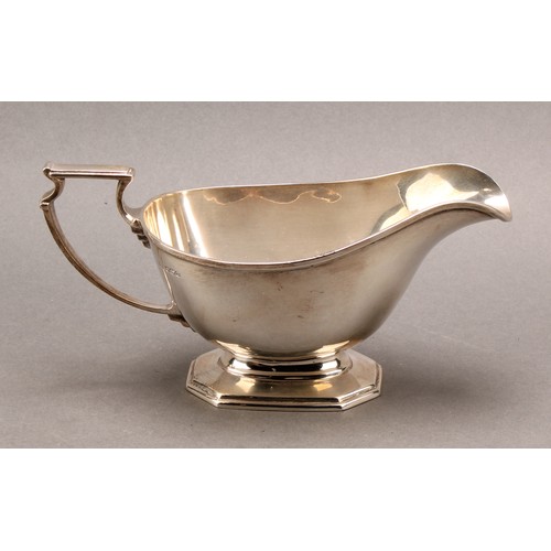 817 - A George V silver pedestal sauce boat, angular scroll handle, octagonal base, Mappin & Webb, Sheffie... 