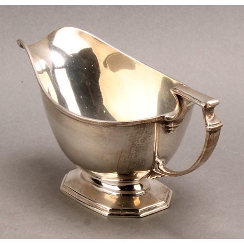 817 - A George V silver pedestal sauce boat, angular scroll handle, octagonal base, Mappin & Webb, Sheffie... 