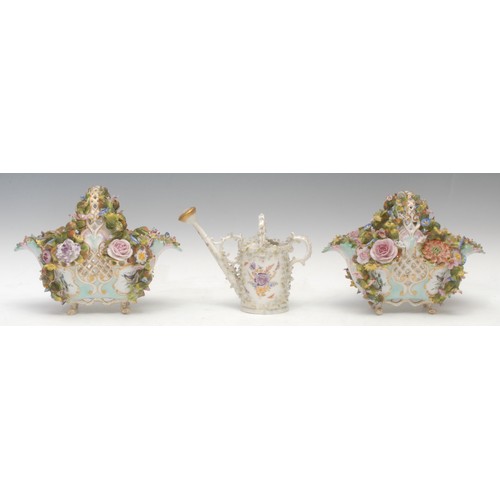 247 - A pair of Continental porcelain baskets, each profusely encrusted with colourful flowers, with shape... 