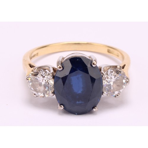 1173 - 18ct yellow gold Sapphire and Diamond Trilogy Ring
The ring is set with an approx. 4.59ct oval brill... 