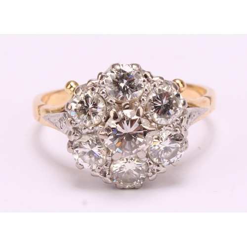 1264 - Tested 18ct gold seven stone Diamond cluster ring
The ring has a centre round brilliant cut diamond ... 