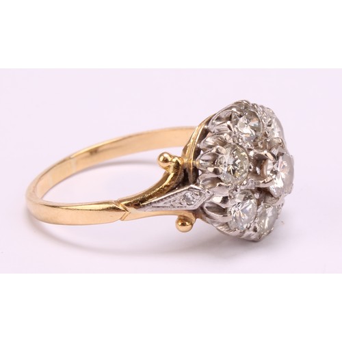 1264 - Tested 18ct gold seven stone Diamond cluster ring
The ring has a centre round brilliant cut diamond ... 