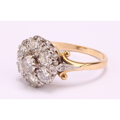 1264 - Tested 18ct gold seven stone Diamond cluster ring
The ring has a centre round brilliant cut diamond ... 