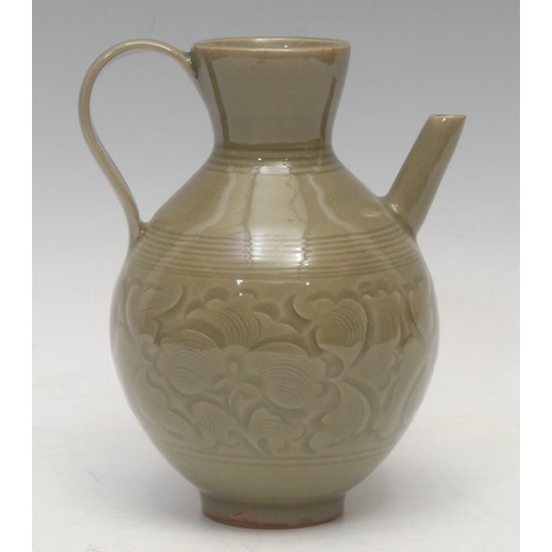 1296 - A Chinese carved celadon ewer, of ribbed ovoid form, incised with a band of lotus leaves, angular sp... 