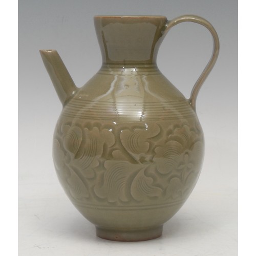 1296 - A Chinese carved celadon ewer, of ribbed ovoid form, incised with a band of lotus leaves, angular sp... 