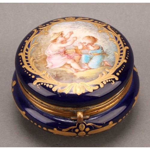 269 - A 'Sevres' porcelain circular dressing table box, the hinged cover painted with two children releasi... 