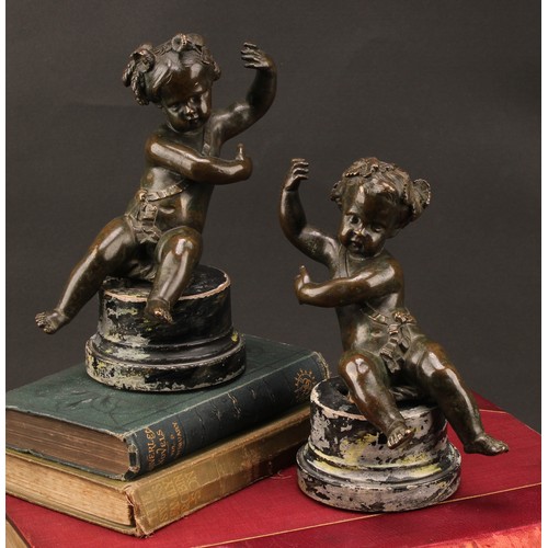 2403 - After Claude Michel Clodion (1738-1814), a pair of dark patinated bronze putti allegorical adornment... 