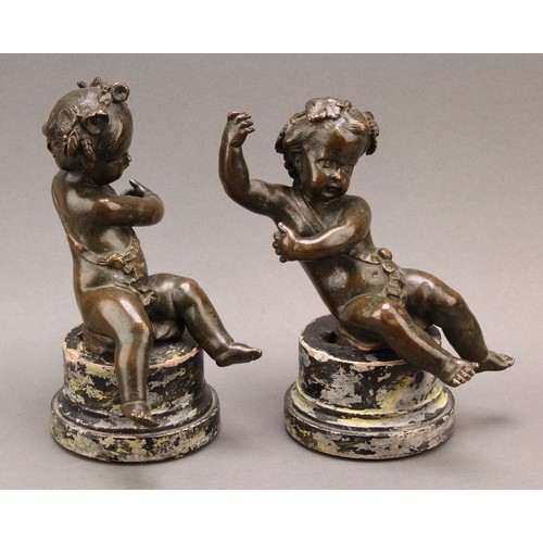 2403 - After Claude Michel Clodion (1738-1814), a pair of dark patinated bronze putti allegorical adornment... 