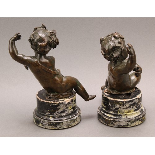 2403 - After Claude Michel Clodion (1738-1814), a pair of dark patinated bronze putti allegorical adornment... 