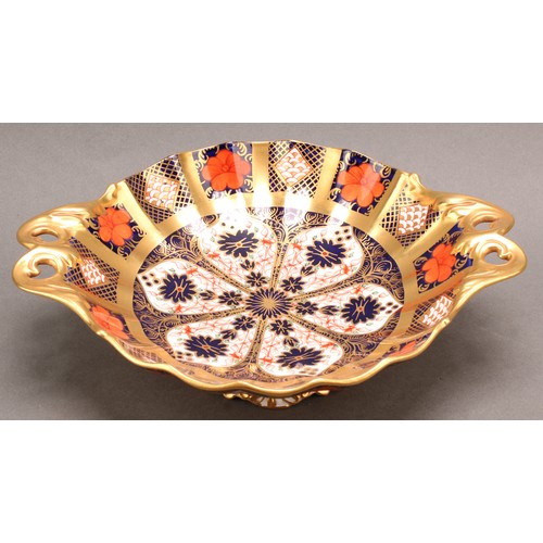 192 - A Royal Crown Derby 1128 Imari pattern Duchess pedestal dish, solid gold band, leafy scroll handles,... 