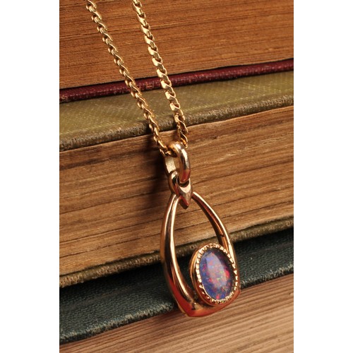 1174 - 9ct gold black opal doublet pendant with 18ct gold fine chain
pendant contains an oval cabochon blac... 