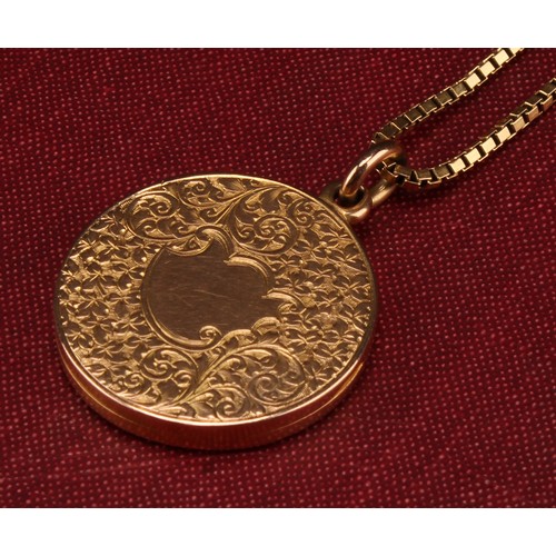 1165 - 15ct gold round floral design locket with a fine 18ct box link chain 
The round locket is hallmarked... 