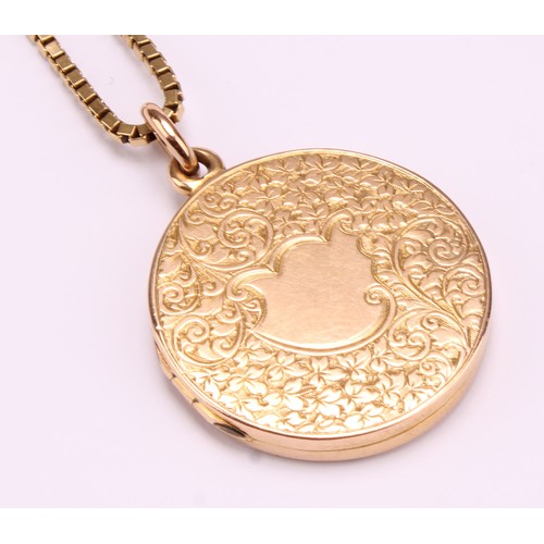 1165 - 15ct gold round floral design locket with a fine 18ct box link chain 
The round locket is hallmarked... 