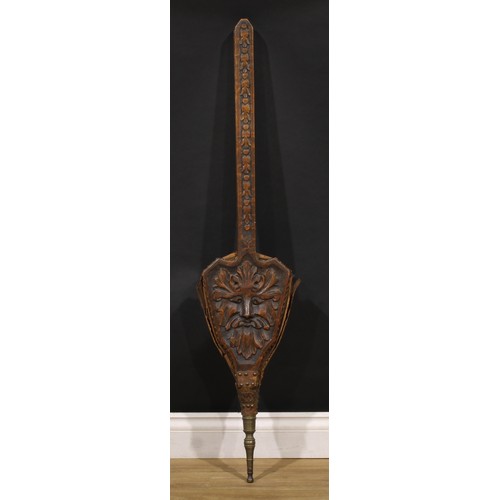 1968 - A 19th century oak set of long-handled bellows, boldly carved with Green Man foliate mask, studded l... 