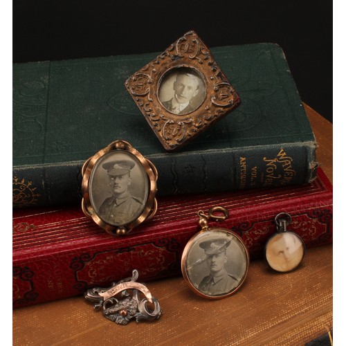 1228 - A Selection of photo frame pendants, brooches and a miniature gilt red leatherette photo frame 
To i... 