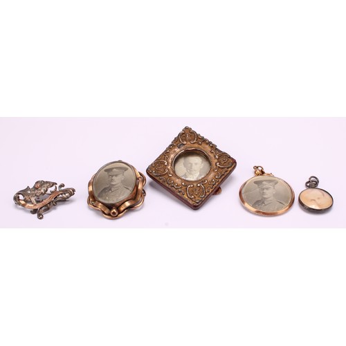 1228 - A Selection of photo frame pendants, brooches and a miniature gilt red leatherette photo frame 
To i... 