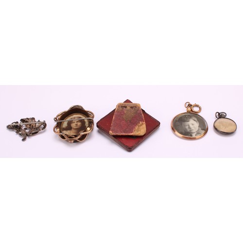 1228 - A Selection of photo frame pendants, brooches and a miniature gilt red leatherette photo frame 
To i... 