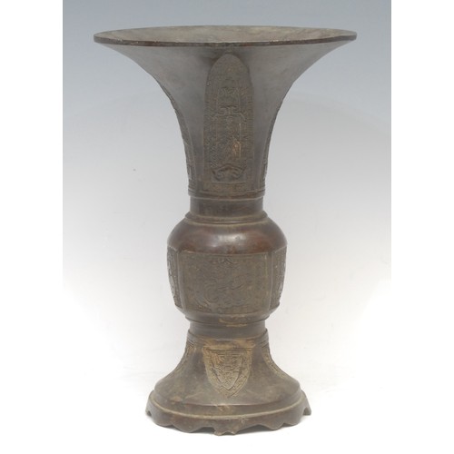 1284 - A Chinese patinated bronze gu vase, cast in the Archaic taste, 27cm high, Yuan Dynasty character mar... 