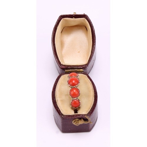 1234 - A Tested 9ct gold Coral ring,
set with five graduated round cabochon corals that measure between app... 