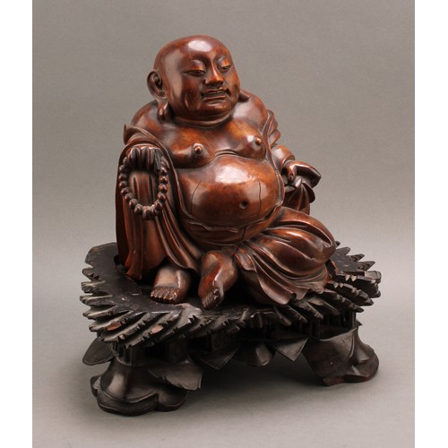 1286 - A 19th century Chinese carved hardwood figure of Putai or Buddha, seated scantily draped in robes ho... 