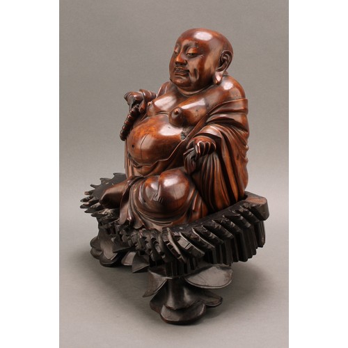 1286 - A 19th century Chinese carved hardwood figure of Putai or Buddha, seated scantily draped in robes ho... 