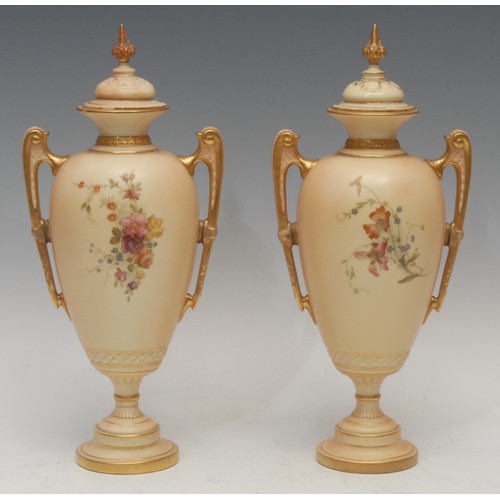 137 - A pair of Royal Worcester two-handled slender ovoid pedestal vases and covers, decorated with flower... 