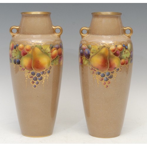 128 - A pair of Royal Worcester amphora shaped vases, painted with ripening fruit, outlined in gilt, on a ... 