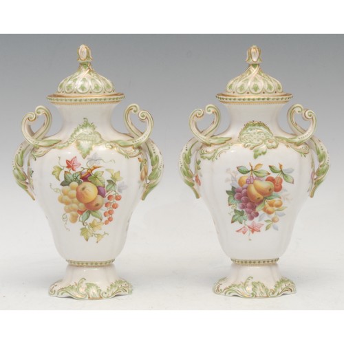 94 - A pair of Copeland two-handled pear shaped pedestal vases and covers, in the rococo manner, painted ... 