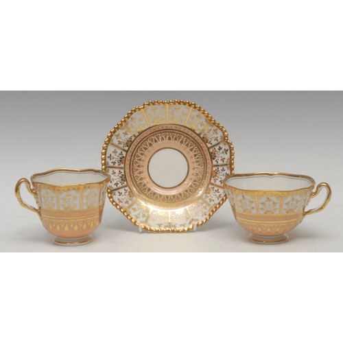 37 - A  Flight Barr Worcester trio, decorated with floral gilt panels over a salmon pink band, shaped mou... 