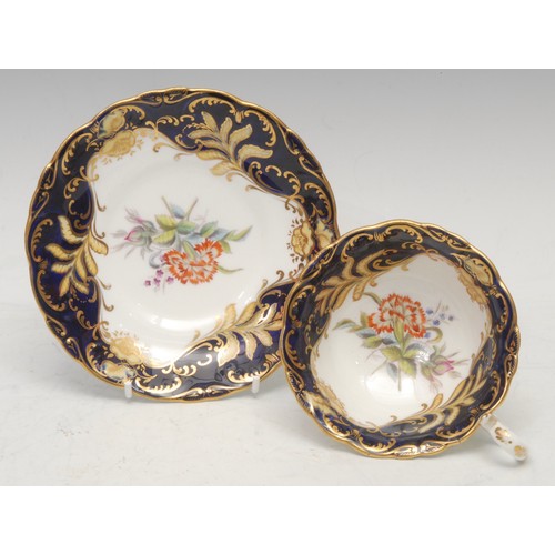 46 - A Chamberlains Worcester coffee cup and saucer, decorated with circular and oval gilt bosses, on a c... 