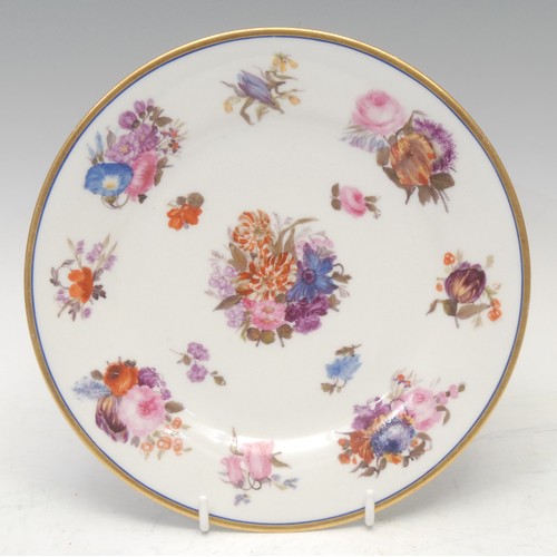 63 - A Flight Barr and Barr circular plate, finely painted with tight floral bouquets, blue and gilt line... 