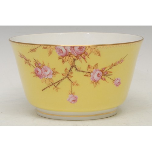 107 - A Royal Worcester bowl, in Japanesque style, painted with pink roses on gilt branches, yellow ground... 