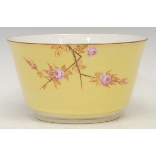 107 - A Royal Worcester bowl, in Japanesque style, painted with pink roses on gilt branches, yellow ground... 