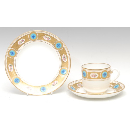 84 - A Minton coffee cup, saucer and side plate, gilt acid borders with alternating floral reserves and t... 