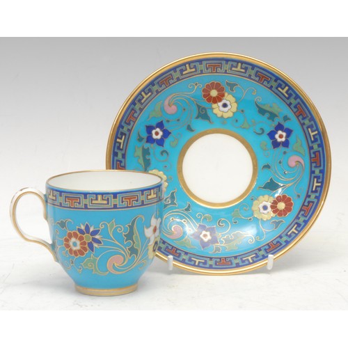 83 - A Minton coffee cup and saucer, decorated in polychrome with raised enamel flowers on a turquoise gr... 