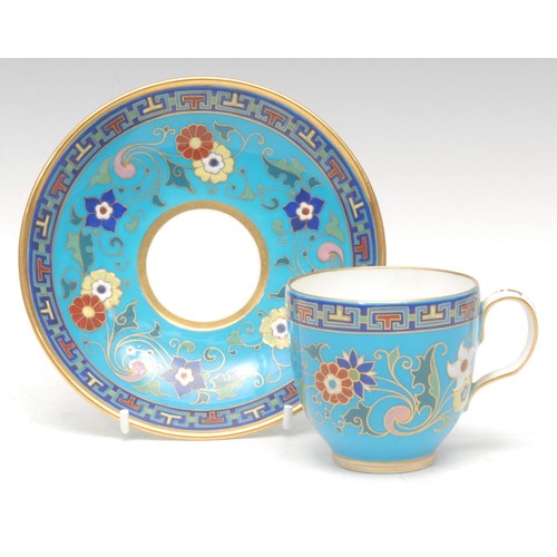 83 - A Minton coffee cup and saucer, decorated in polychrome with raised enamel flowers on a turquoise gr... 