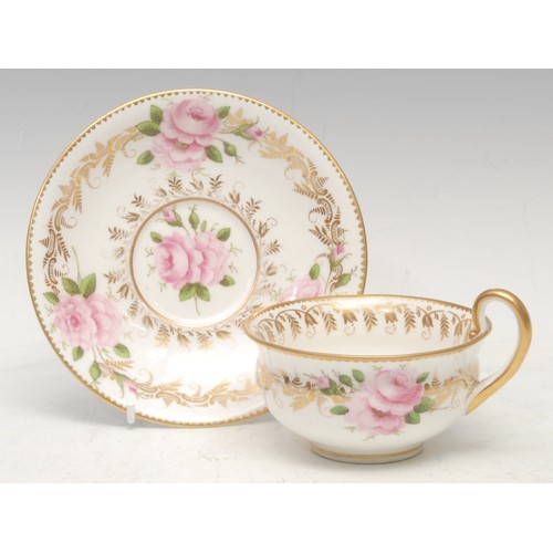 66 - A Flight Barr and Barr teacup and saucer, decorated with a gilt flower and foliate scroll, within a ... 