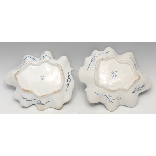 88 - A near pair of large Bow leaf shaped dishes, painted in dark blue with grape and vine, the largest 2... 